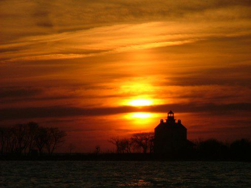 St. Clements Island lighthouse sunset. Copyright THE CHESAPEAKE St. Clement's Island with the sun setting behind the Blackiston Lighthouse. Copyright 2010 THE CHESAPEAKE