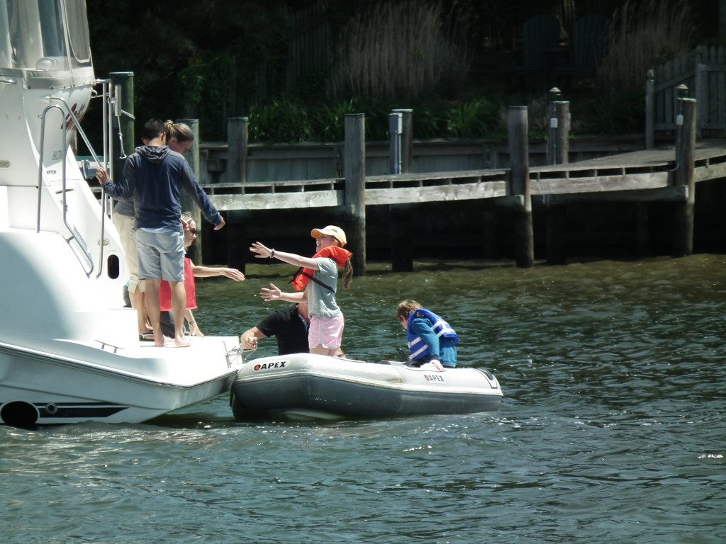 A helping hand. From tender to cruiser in the harbor at St. Michael's, Md. THE CHESAPEAKE TODAY photo