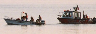Police and Second District VFD fireboat drag for a drowning victim at Piney Point on the Potomac River. THE CHESAPEAKE TODAY photo