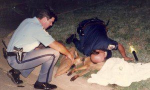 First aid for downed pooch from St. Mary's County Sheriff's Deputies Darryl Greb, left and William Bell, right. See more of top cops at work in The Story of The Rag in eBook, paperback and Audible