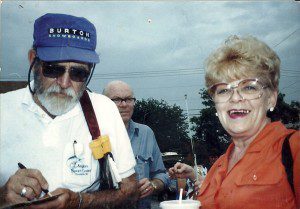 Bill Burton reported on the Great Solomon's Island Fish-In in 1989. Calvert County Commissioner Barbara Stinnett, right, waits while Burton pens a note. THE CHESAPEAKE TODAY photo