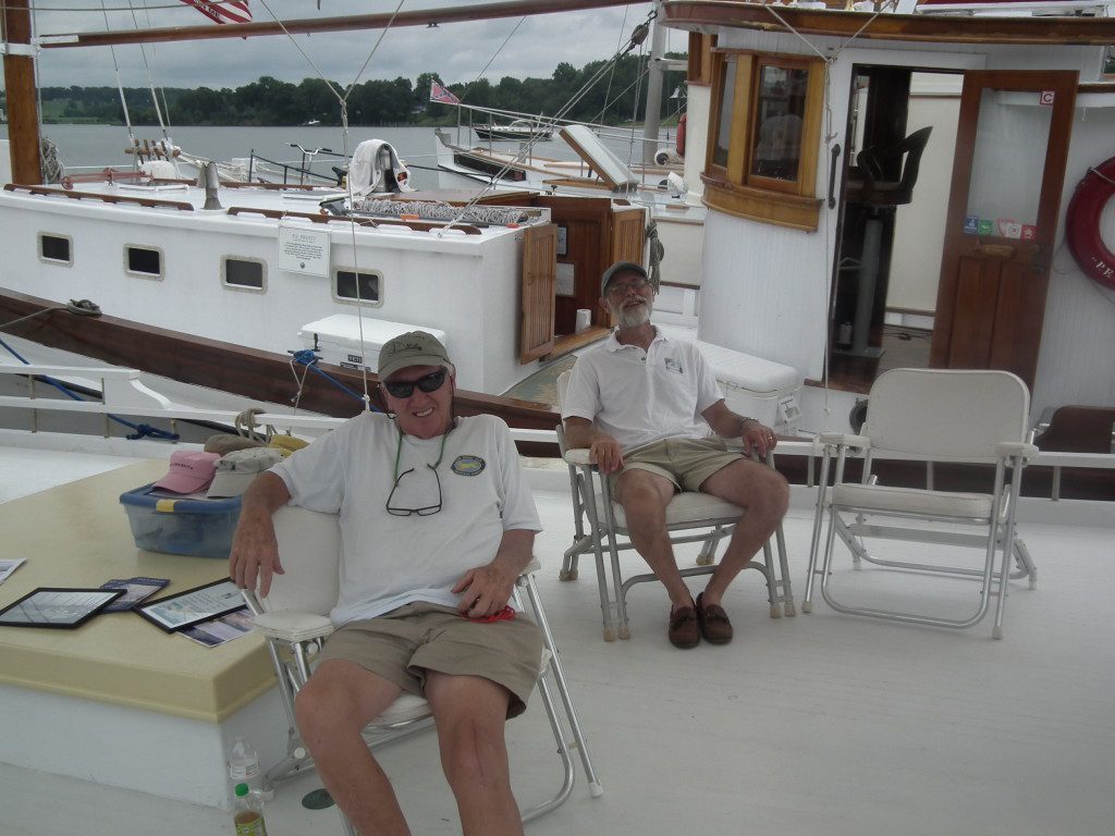 After a hard day sailing up the Potomac these captains prepare for explaining to visitors what a buyboat is and how they functioned. John England, at center, led the effort to save the F.D. Crockett, the oldest log boat in Virginia. THE CHESAPEAKE TODAY photo