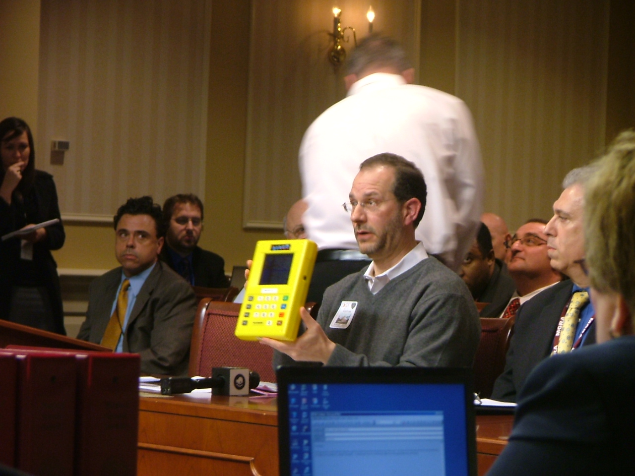 Bingo pull tab displayed at slots hearing as Maryland lottery official Paul Dorsey listens. 