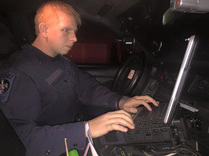 St. Mary's Sheriff Deputy Anthony Cole writing ticket on computer.