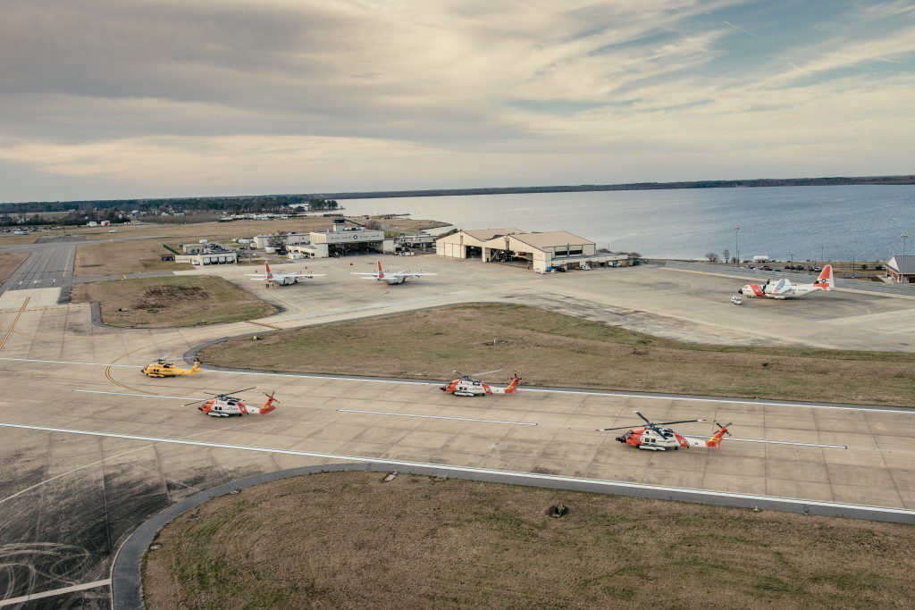 Coast Guard Dolphin Helicopter crews prepare to fly flight formations at the Wright Brothers National Memorial, Wednesday, March 10, 2016. Air Station Elizabeth City helicopter crews were at Kill Devil Hills to celebrate the centennial anniversary of the Coast Guard's aviation program with formation flights and a classic painting scheme. (U.S. Coast Guard photo illustration by Auxiliarist David Lau)