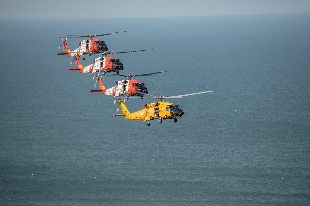 Coast Guard Dolphin helicopters fly flight formations at the Wright Brothers National Memorial, Wednesday, March 10, 2016. Air Station Elizabeth City helicopter crews were at Kill Devil Hills to celebrate the centennial anniversary of the Coast Guard's aviation program with formation flights and a classic painting scheme. (U.S. Coast Guard illustration by Auxiliarist David Lau)