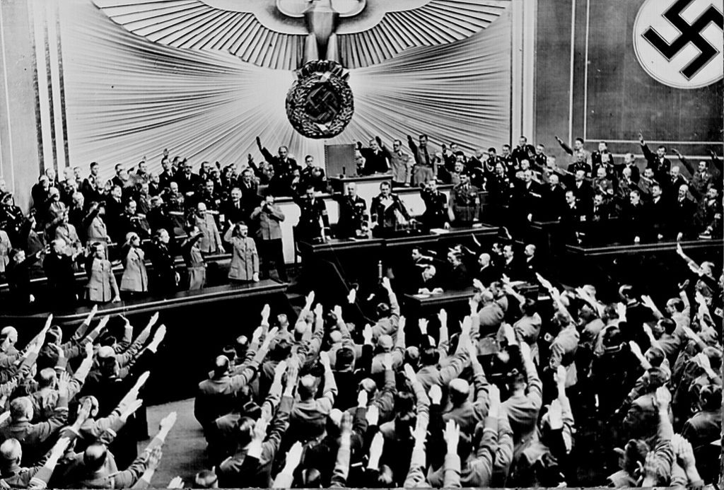 Hitler accepts the ovation of the Reichstag after taking Austria. Next was Czechoslovakian Sudetenland, largely inhabited by a German- speaking population. Berlin, March 1938. 208-N-39843
